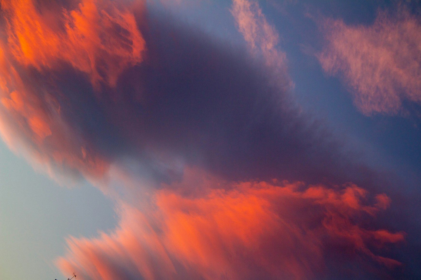 a blue sky with a lot of red and orange clouds