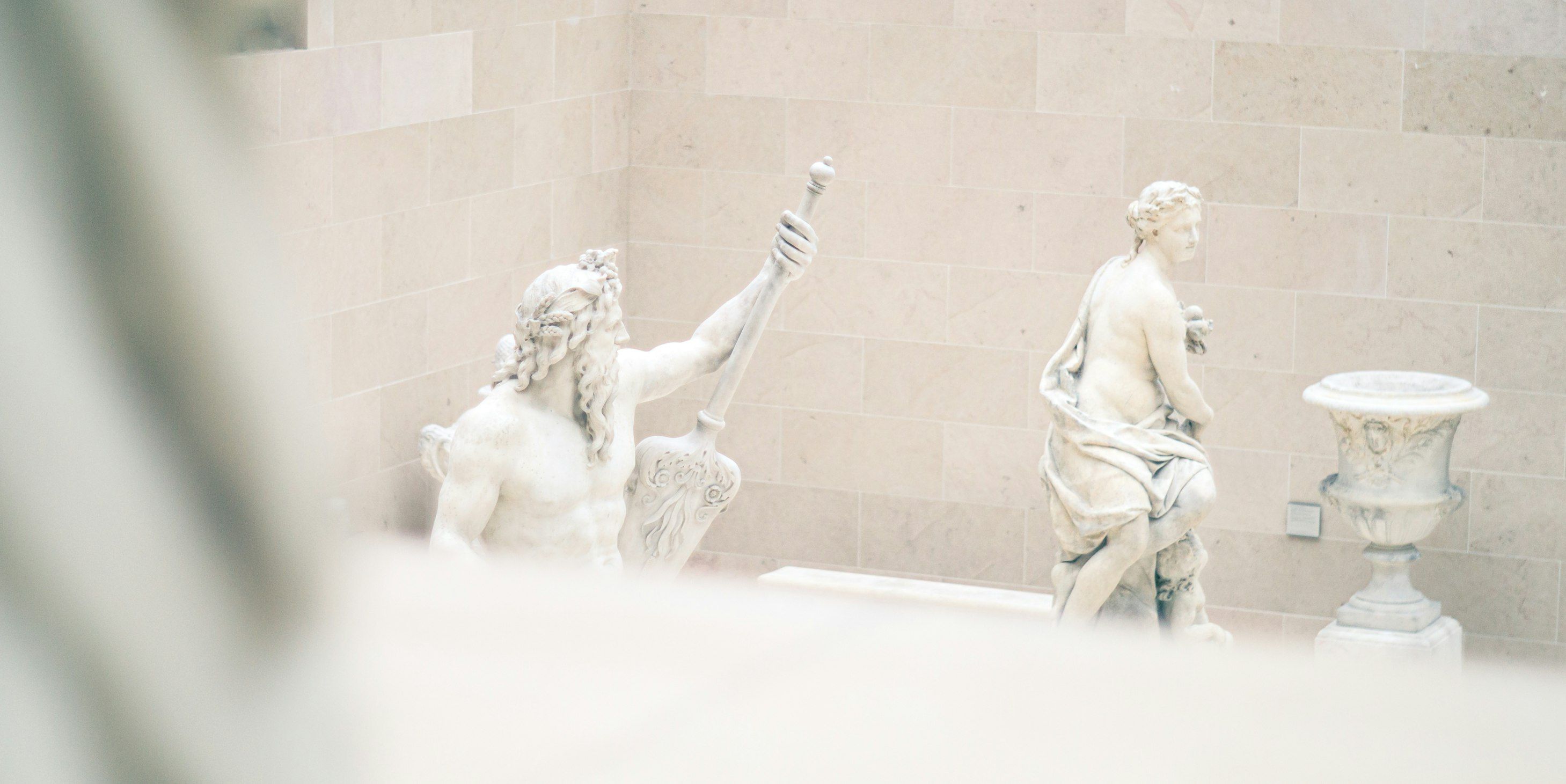 a statue of a man next to a statue of a woman