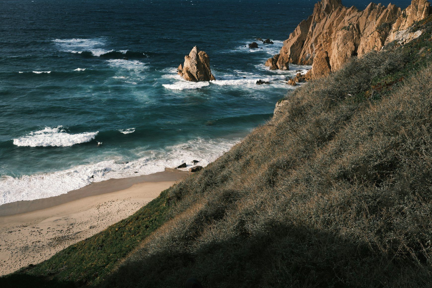 a view of the ocean from the top of a hill